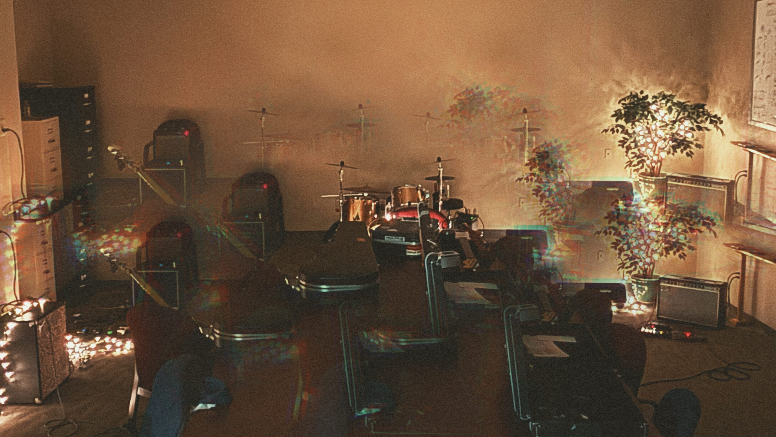 Slim Volume rehearsal space showing guitars, amps, and drums