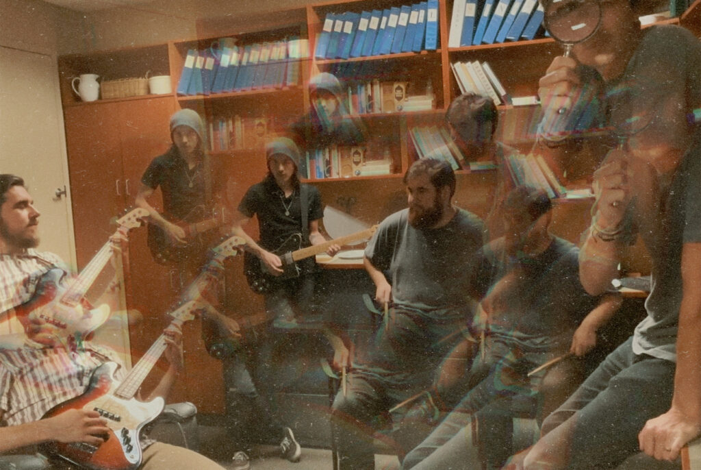 a glitched and blurry office picture of slim volume featuring jake deschuiteneer, ian anderson, jonny lawrence, and trent larrabee